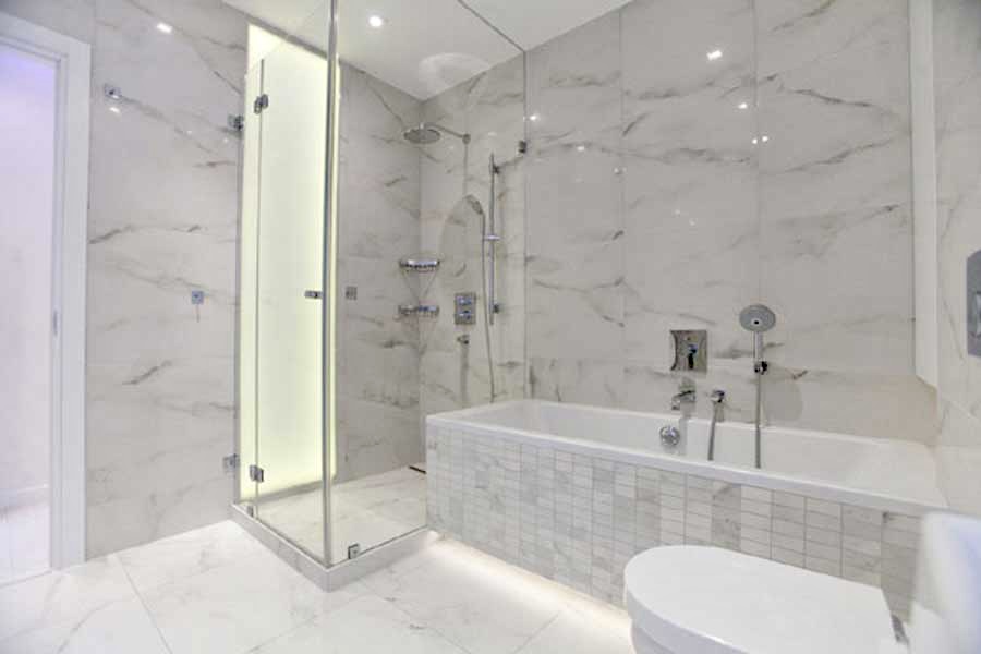 Marble bathroom with glass walk-in shower and soaking tub