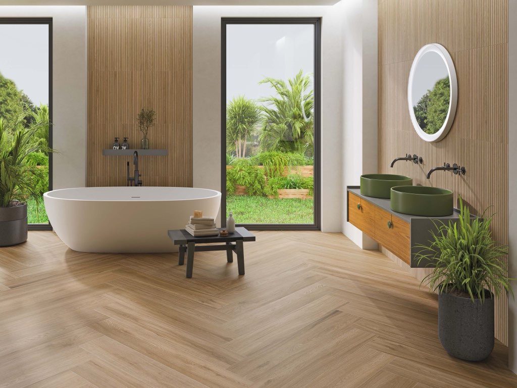 Spa bathroom with herringbone floor, wood vanity, and freestanding tub