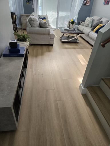 Light wood-look flooring installed through an open living room